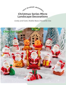 Miniature Christmas resin figurines set with Santa Claus and Snowman on snow landscape