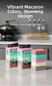 Close-up of five colorful high-density kitchen sponges on a modern marble countertop
