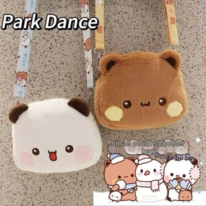 Close-up of cute plush crossbody bags in white and brown with patterned straps