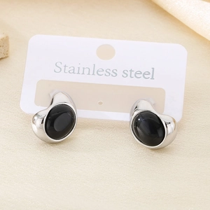 Detailed shot of silver stainless steel earrings with black oval stones on a card