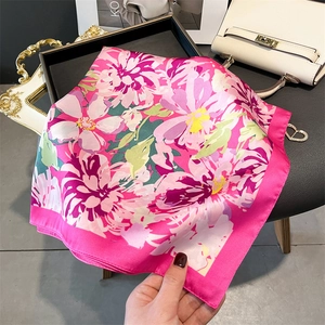 Detail of floral silk scarf in magenta with draped texture and premium gloss finish