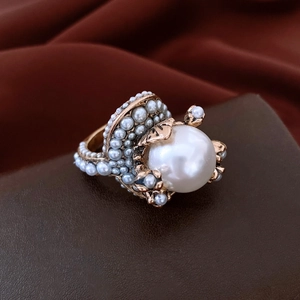 Macro shot of vintage style ring with large central pearl and antique gold finish