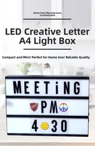 Front view of A4 LED letter cinematic light box with black frame on a wooden table