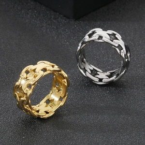 Detail of minimalist X-shaped cutout stainless steel rings in gold and silver finish