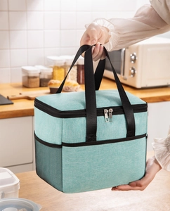 Detail of light blue insulated lunch bag featuring mesh side pocket and sturdy dual zippers