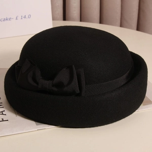 Dettaglio dell'elegante cappello in feltro di lana nero con fiocco vintage e cupola