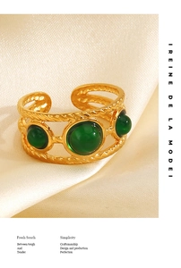 Detail of a vintage 18K gold plated twisted ring featuring three green resin stones
