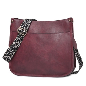 Detail of burgundy PU leather tote bag with stylish leopard print wide shoulder strap