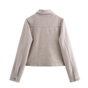 Rear view detail of a light grey cropped jacket showing thick wool-like texture and seams