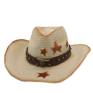 Detailed view of western straw hat featuring a metal bull head icon and star patterns