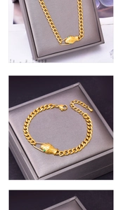 Detailed view of golden snake-head clasp with green gem eyes and chunky chain texture