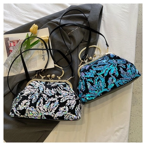 Detail of sequined shell bags in silver and blue with gold metal handles and frames