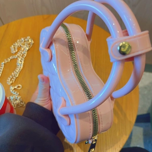 Close-up of pink PVC jelly bag showing glossy texture and metal zipper detail
