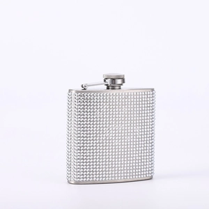 Detail of a sparkling rhinestone-covered 6oz stainless steel hip flask on white background
