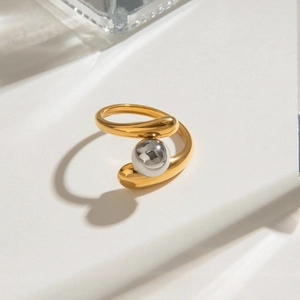 Detailed macro view of a two-tone gold ring with silver bead and open adjustable frame