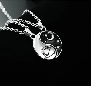 Macro view of yin yang necklace set with sun mountain and moon star detail