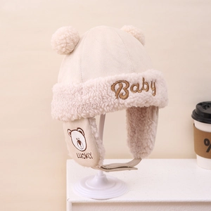 Detail of beige baby winter trapper hat with bear embroidery and plush ear flaps