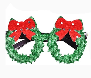 Detail of green wreath Christmas glasses with red glitter bow and sparkle texture