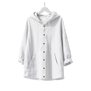 Détail d'une chemise en lin blanc montrant des boutons en bois et le tissu naturel