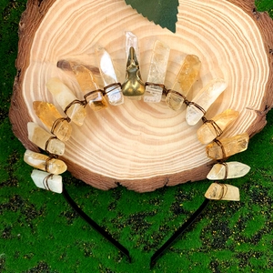 Handmade citrine and white crystal crown headband with a bird skull centerpiece on wood