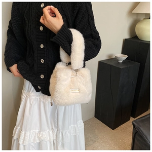 Close-up of fluffy off-white faux fur bucket bag with LOVE EVERYDAY woven label