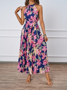 Macro view of pleated floral fabric texture and waist tie on navy halter maxi dress