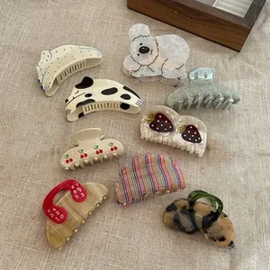 Detailed flat lay of diverse patterned hair claws with cow print and animal designs