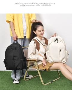 Detail of minimalist school backpacks in black and beige with durable nylon fabric