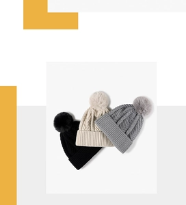 Detailed close-up showing texture of knit beanies with faux fur pom poms and ribbed cuffs