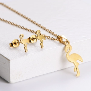 Golden flamingo jewelry set featuring mirror-polished pendant necklace and stud earrings