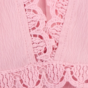 Pink V-neck dress with sweet lace details and textured fabric for a feminine summer look