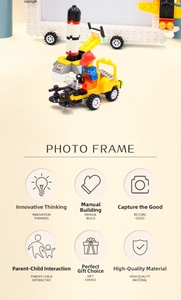 Close-up of DIY building block photo frame with toy rocket and construction vehicle
