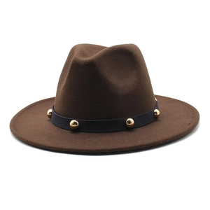 Detailed macro view of dark brown wool fedora hat with gold studded hatband trim