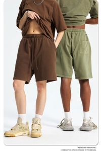 Detail of loose fit cotton shorts with adjustable drawstring and elastic waistband for men