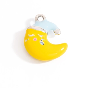 Macro detail of a yellow and blue enamel crescent moon pendant with a sleeping cap design