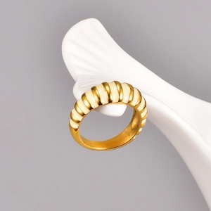 Retro 18K gold plated croissant dome ring with white enamel finish on a white stand