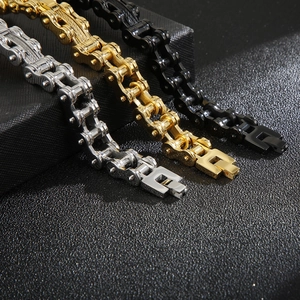 Detailed close-up of motorcycle chain bracelets in gold, silver and black steel finishes