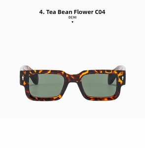 Détail de lunettes de soleil carrées écaillées avec verres verts et rivets en métal