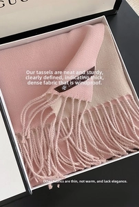 Detail of pink and beige cashmere-style scarf with long fringes in a luxury gift box