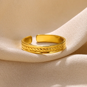 Close-up of golden stainless steel open ring featuring detailed braided rope texture