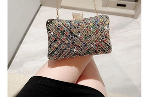 Detail of colorful rhinestone evening bag with gold chain strap held on lap