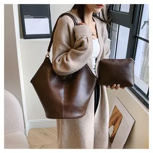 Detail of vintage brown leather tote bag set with a matching zipper inner pouch