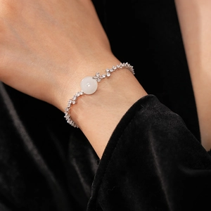 Detail of silver bracelet featuring white chalcedony stone and zircon accents
