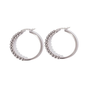 Detail of silver beaded hoop earrings showing the smooth texture and secure clasp closure