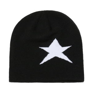 Détail de la texture en maille d'un bonnet d'hiver noir avec motif d'étoile blanche