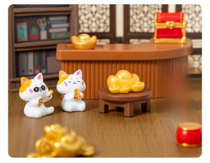 Miniature resin white lucky cats with orange spots on tiny desks and gold ingots
