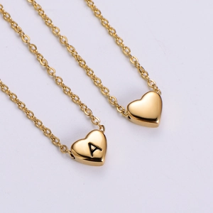 18k gold plated heart necklace with custom letter A pendant on a white background