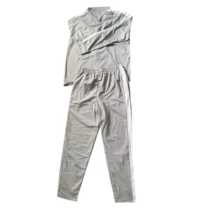 Flat lay of gray casual tracksuit set featuring white side stripes and zip-up collar details
