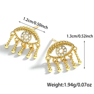 Detail of gold Evil Eye earrings with zircons and tassels showing product dimensions