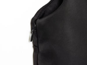 Detail of high-quality invisible zipper on black satin trousers with fine stitching